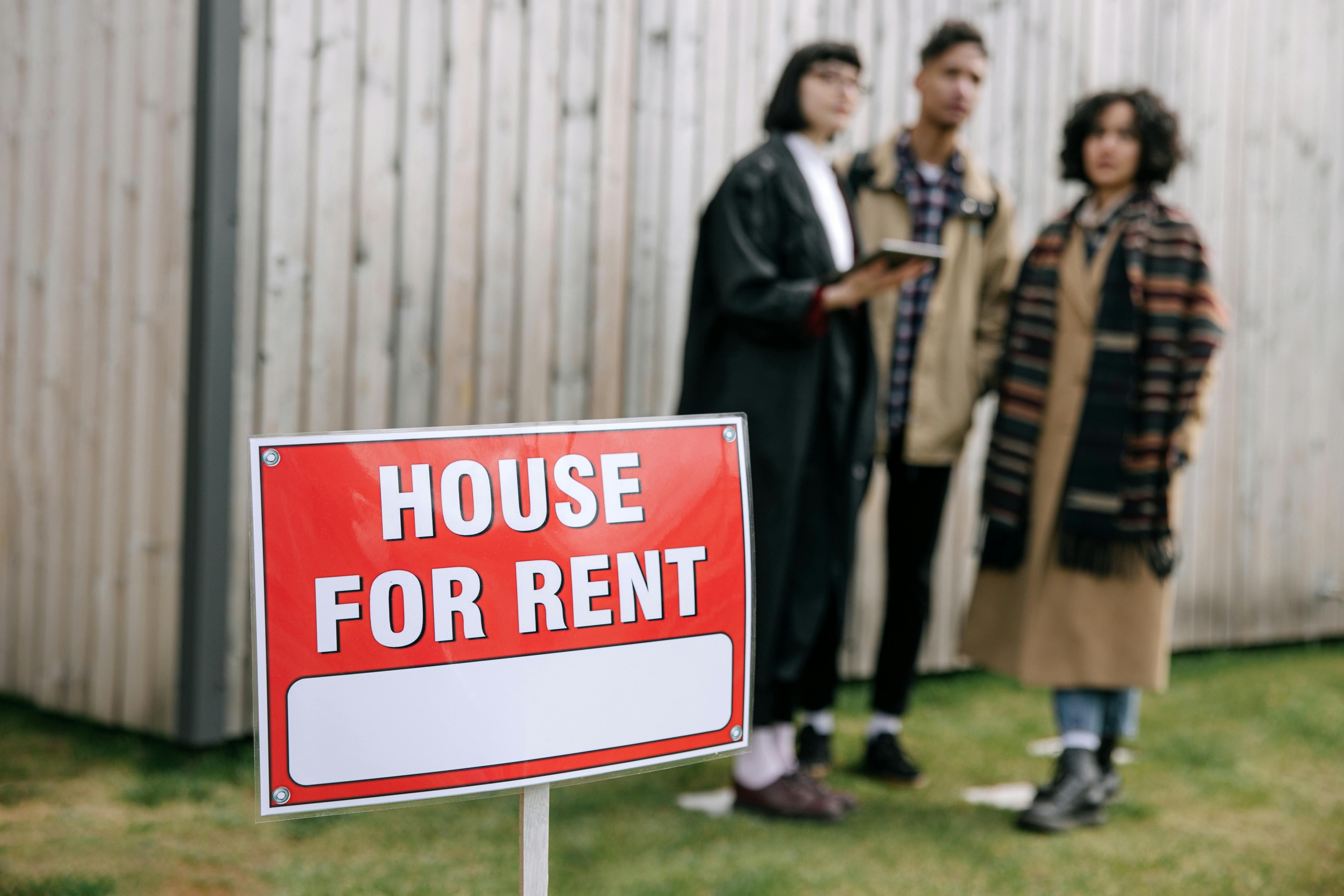 House for rent sign with prospective tenants looking at a Christchurch rental property