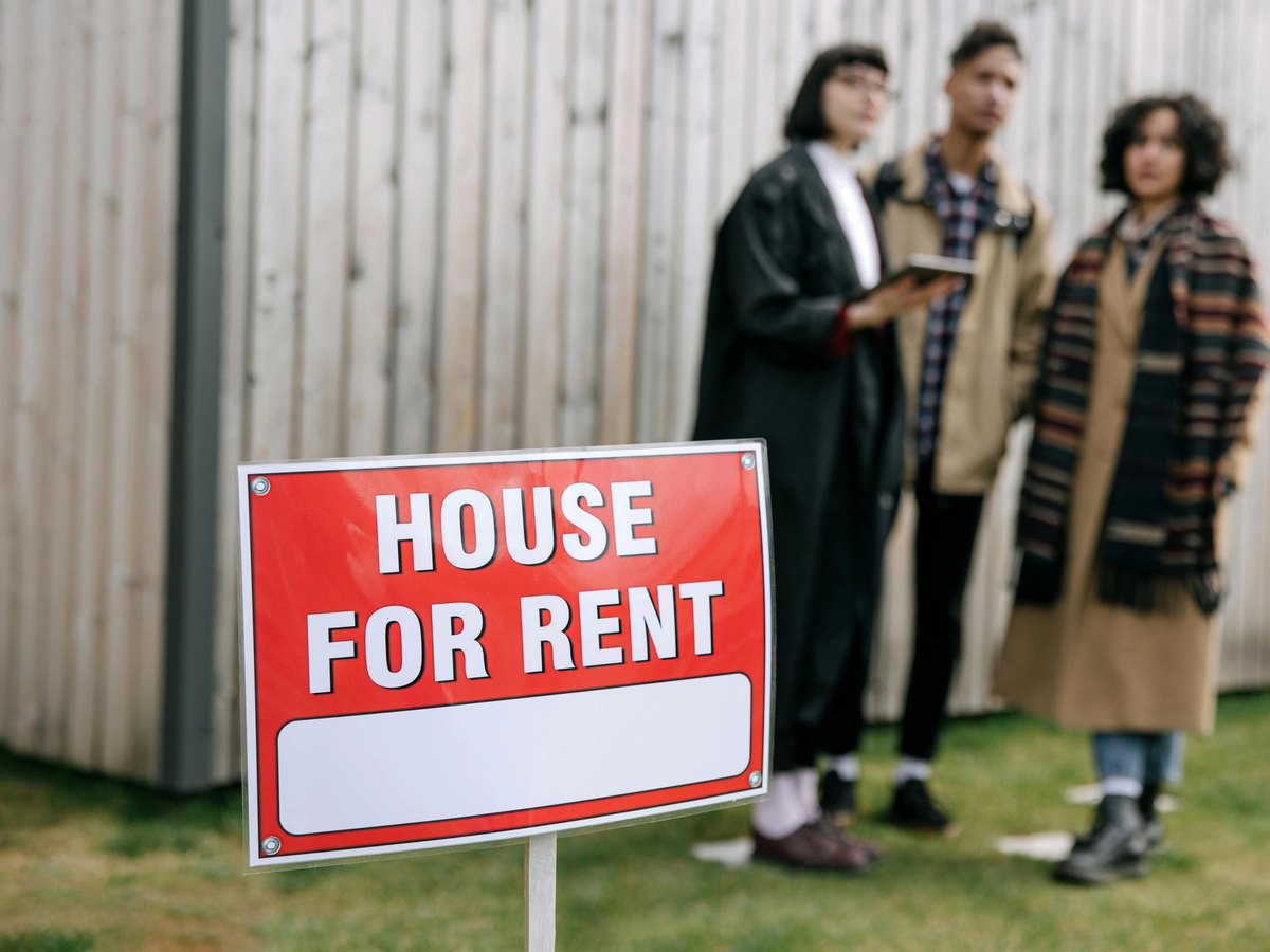 House for rent sign with prospective tenants looking at a Christchurch rental property