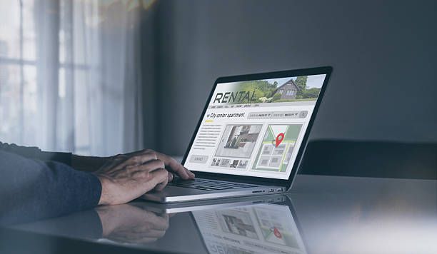 Man looking at a Christchurch property rental website on a laptop