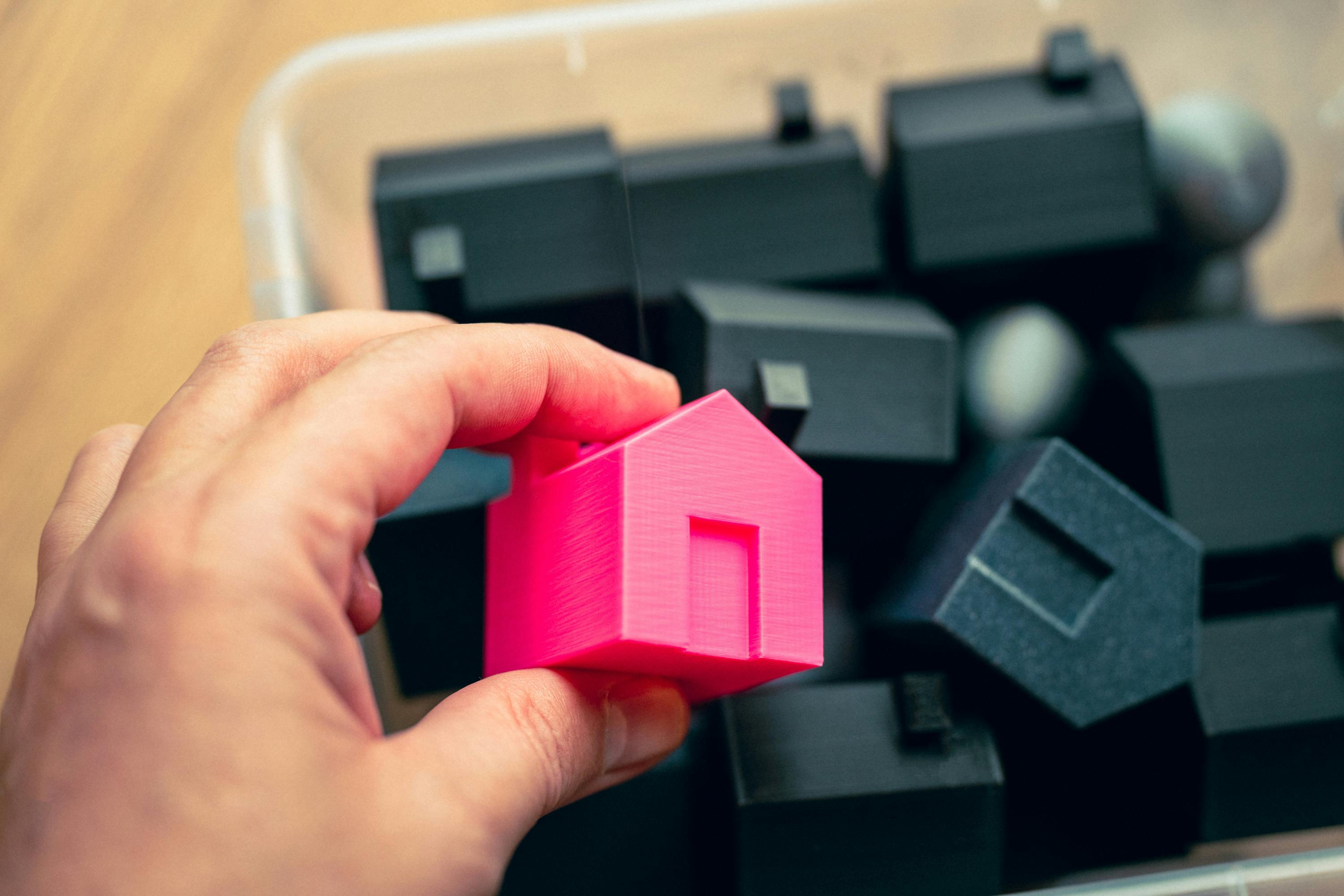 Box of 3D printed plastic houses