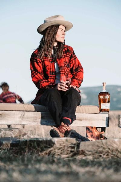 Person on a bench drinking whiskey