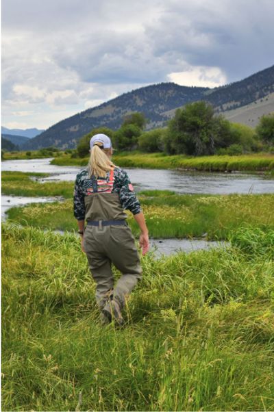 woman walking toward the water