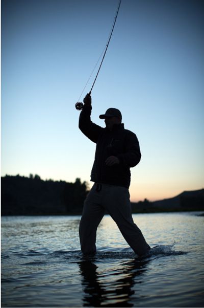 Person standing in the water fly fishing