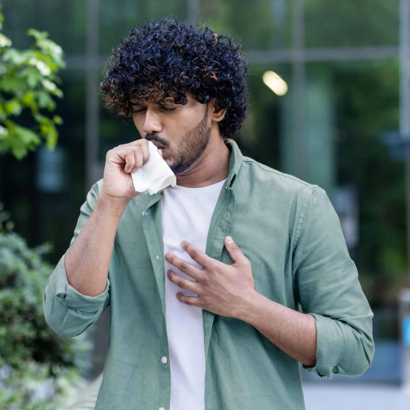 Image of Man Coughing due to Seasonal Allergies.