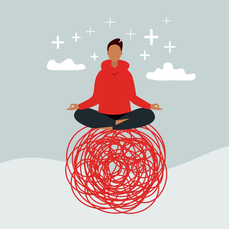 Man Balancing on Red Ball Practicing Meditation