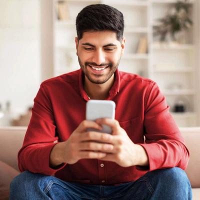 Smiling Man Looking at Phone
