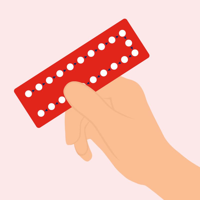 Illustration of Hand Holding Birth Control Packaging