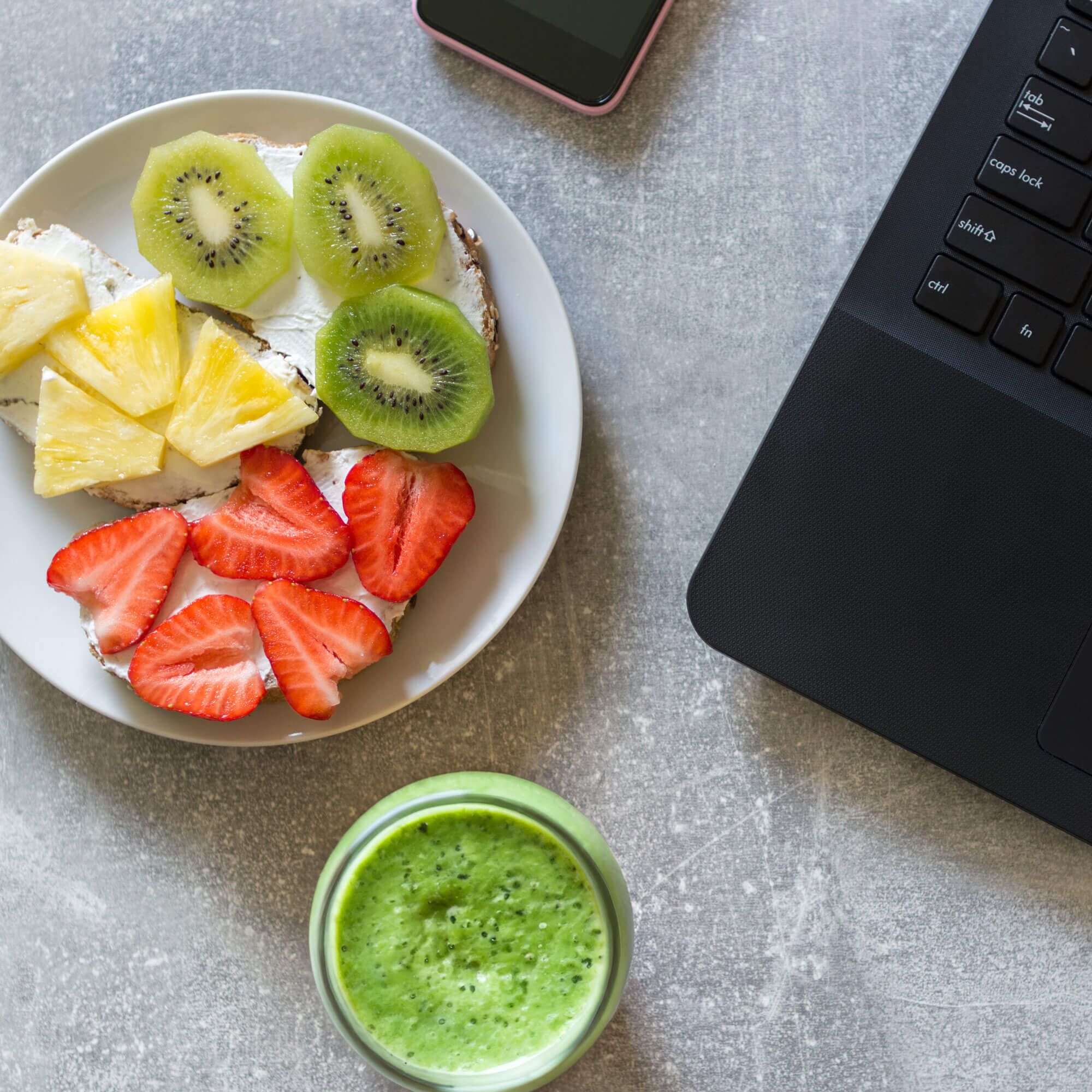 Healthy Fruit Snack Sitting Next to Computer and Phone