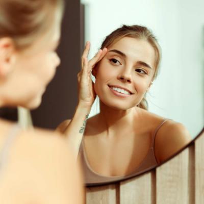 Woman Looking in Mirror at Skin