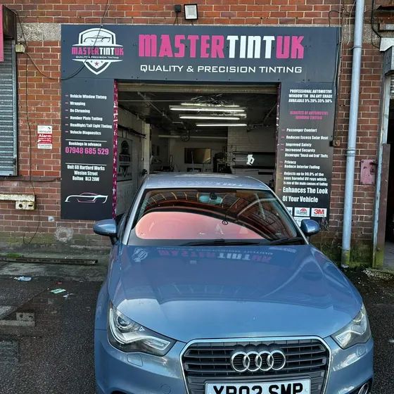 A blue Audi outside our bay with a chameleon windscreen, purple to gold