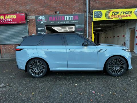 Pale blue Range Rover Sport with dark-tinted rear windows, side on, outside MasterTint UK, Weston Street, Bolton