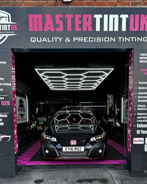Grey Honda Civic Type R in the bay at MasterTint UK, Weston Street, Bolton, seen from the street under the shop sign