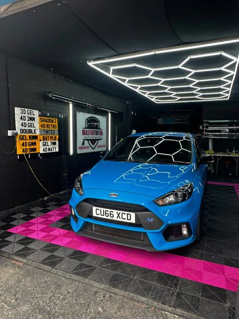 Blue Ford Focus RS in the MasterTint UK bay, Weston Street, Bolton, under the hexagon lights