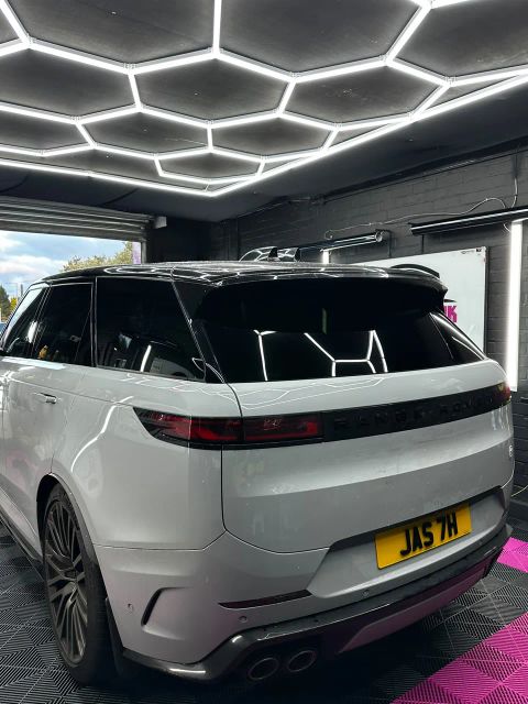 Pale grey Range Rover Sport with dark-tinted rear windows and rear screen in the MasterTint UK bay, Weston Street, Bolton