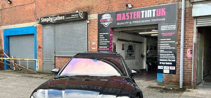 An Audi RS6 front screen with a sunset chameleon tint, outside our unit