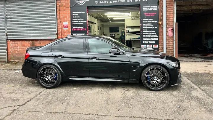 A black BMW M3 Competition outside our bay after 20% rear and 50% front tints
