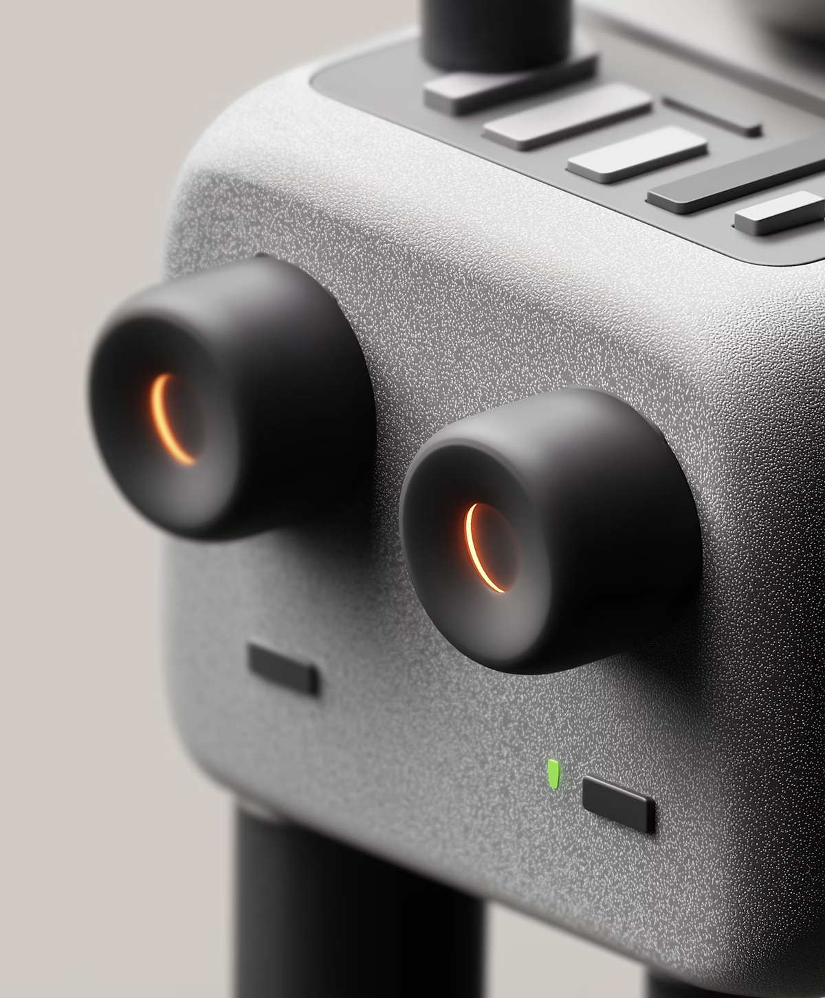 Close-up of a grey device with two black knobs glowing orange