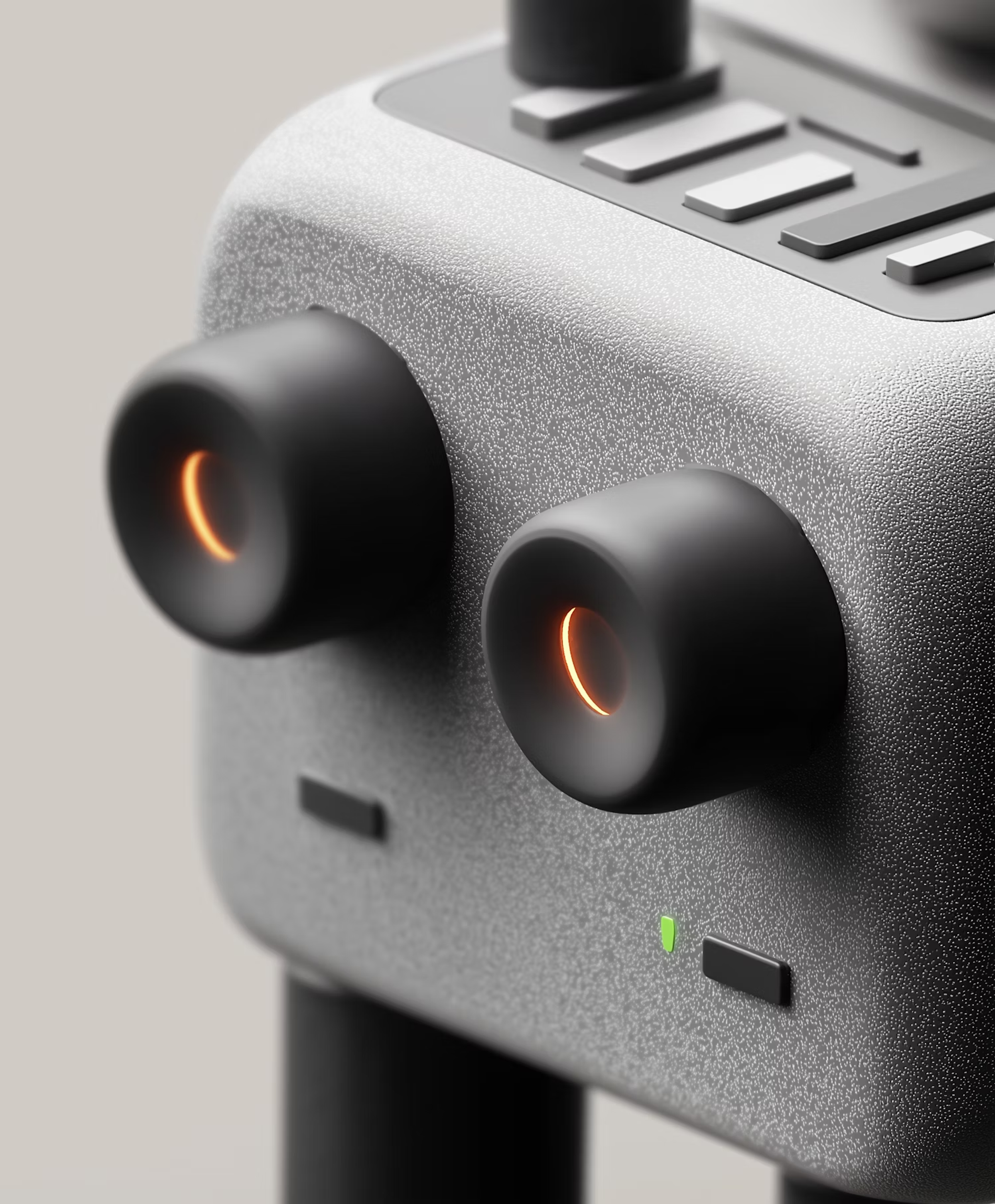 Close-up of a grey device with two black knobs glowing orange