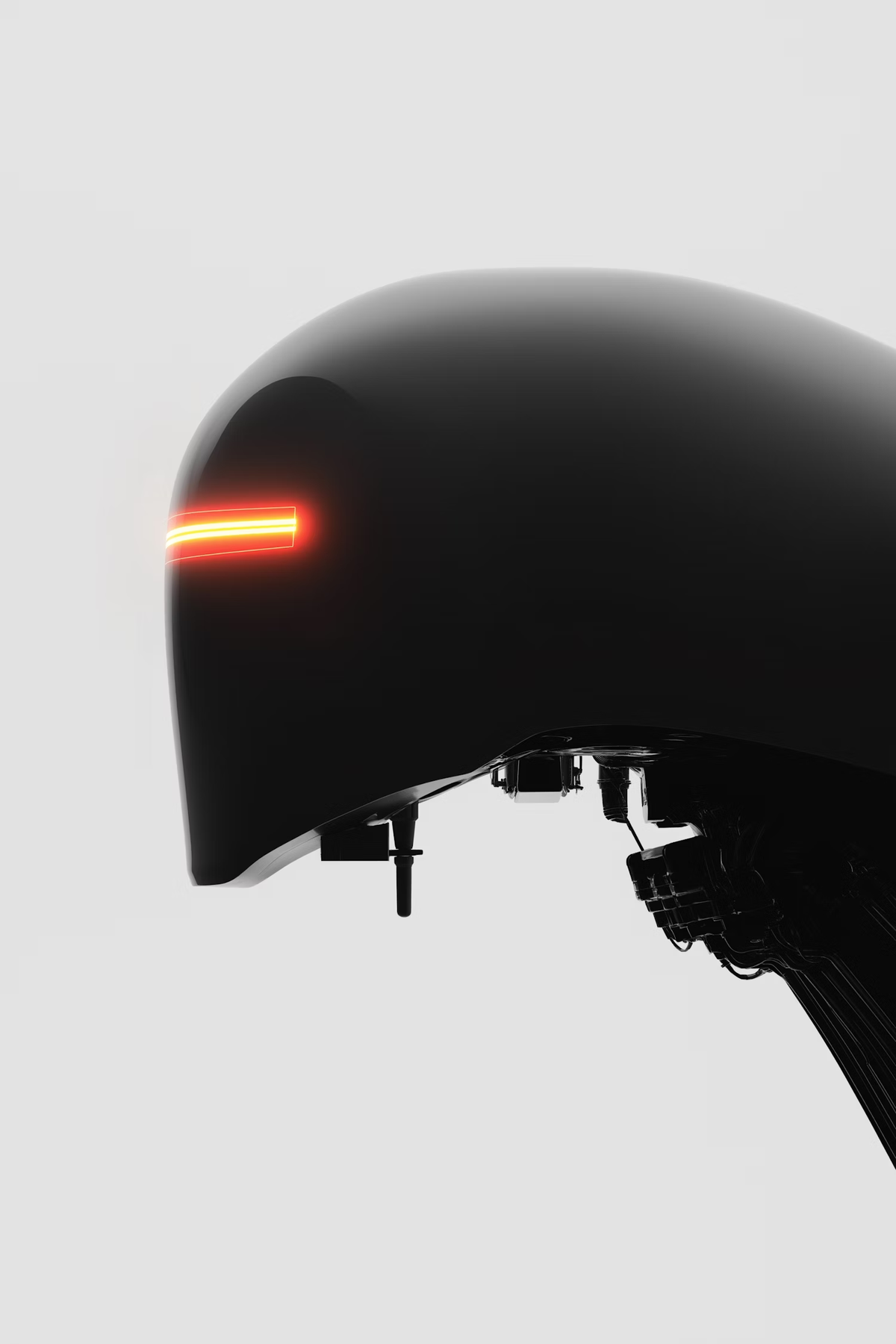 Black helmet-shaped device with a glowing orange light