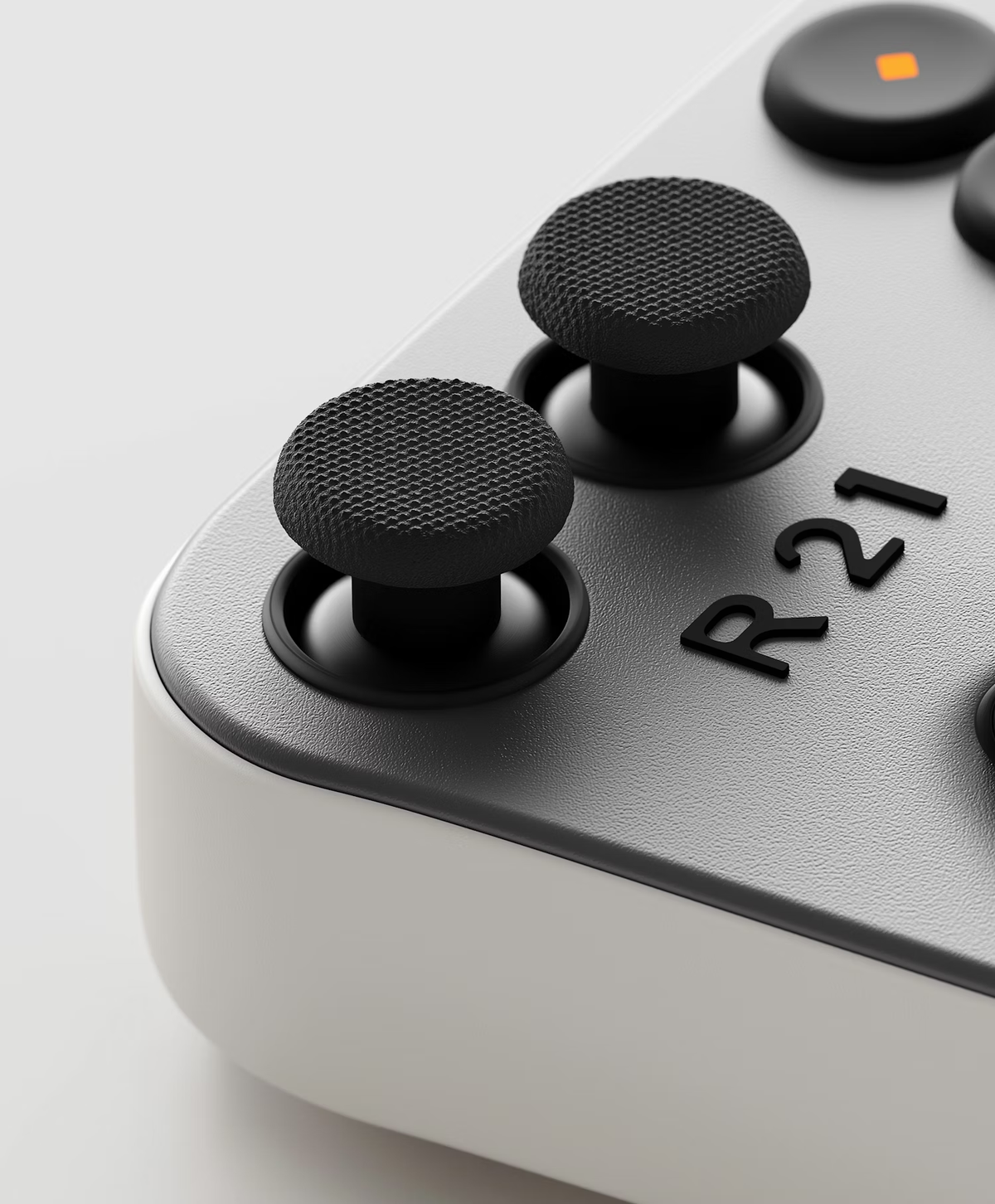 Close-up of a game controller thumbstick marked R21