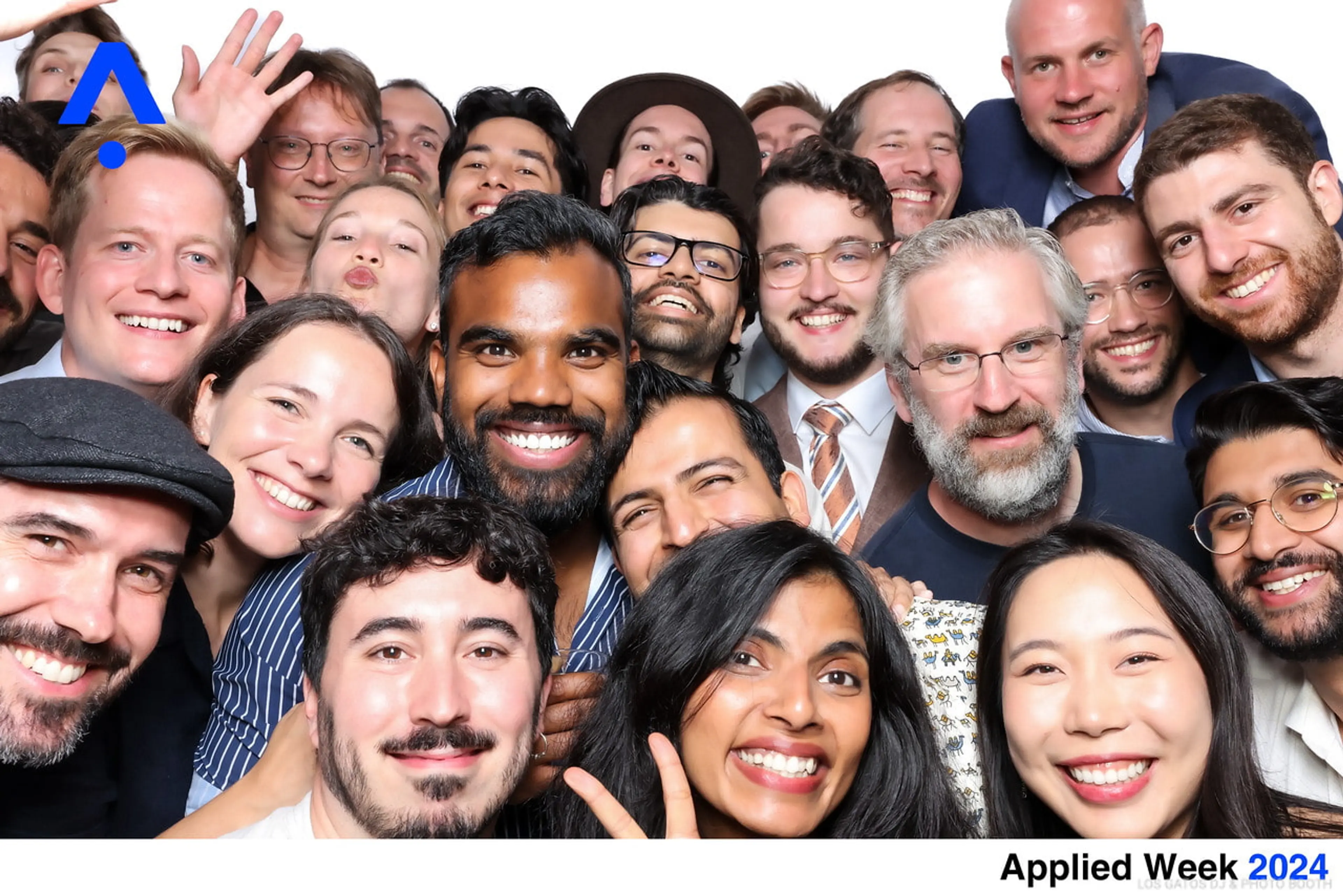 Approximately 26 people in a tight group shot