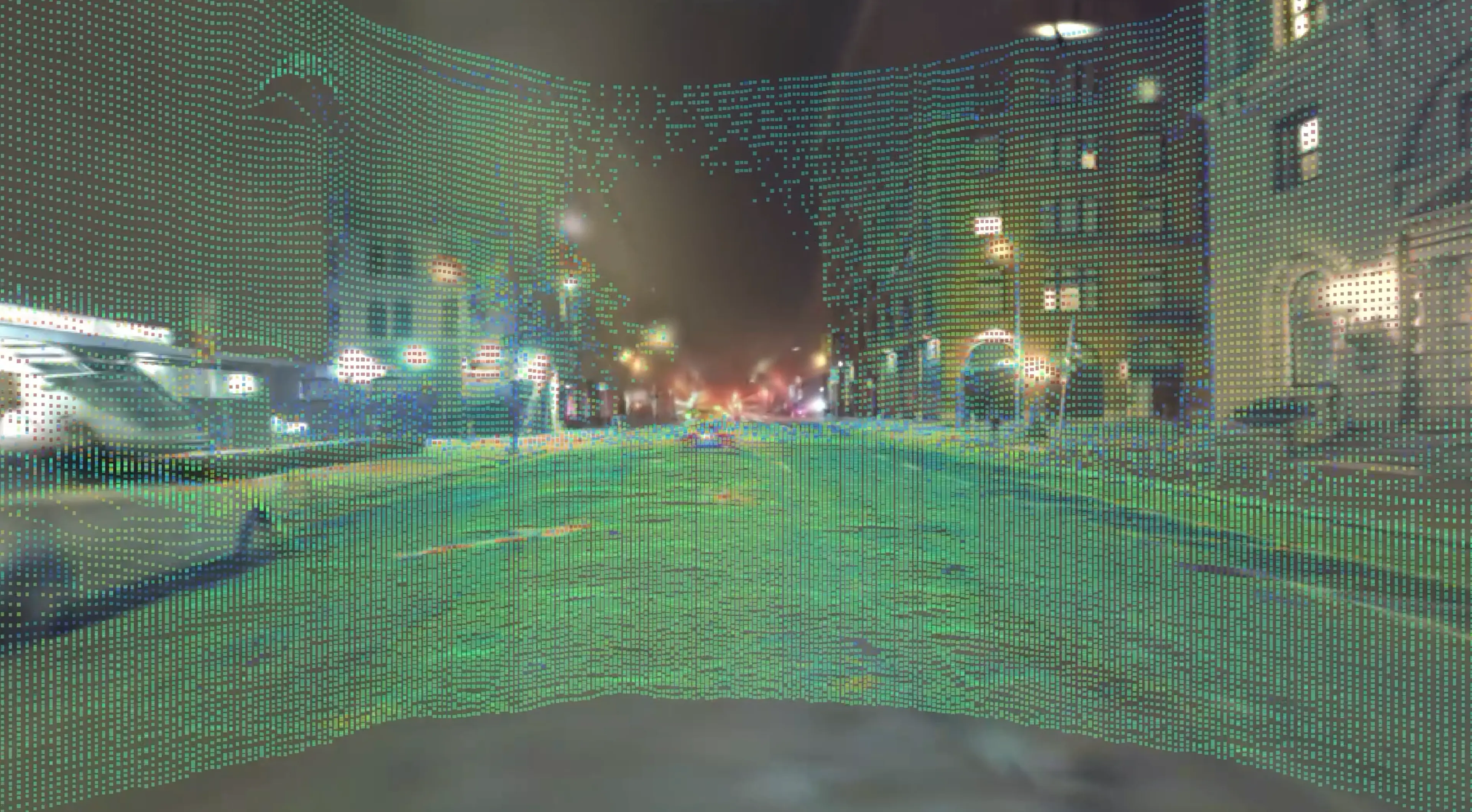 Autonomous vehicle sensor visualization showing a dense green point cloud mapped over a nighttime city street
