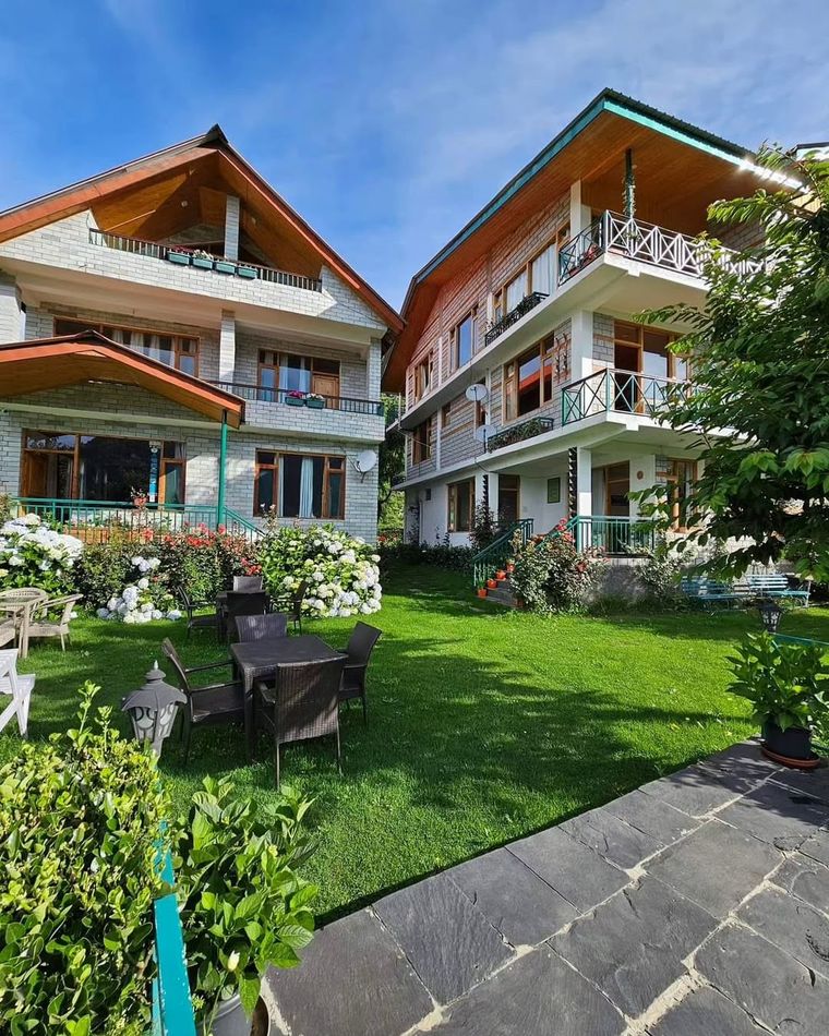 A garden house in Manali, snow-capped views.