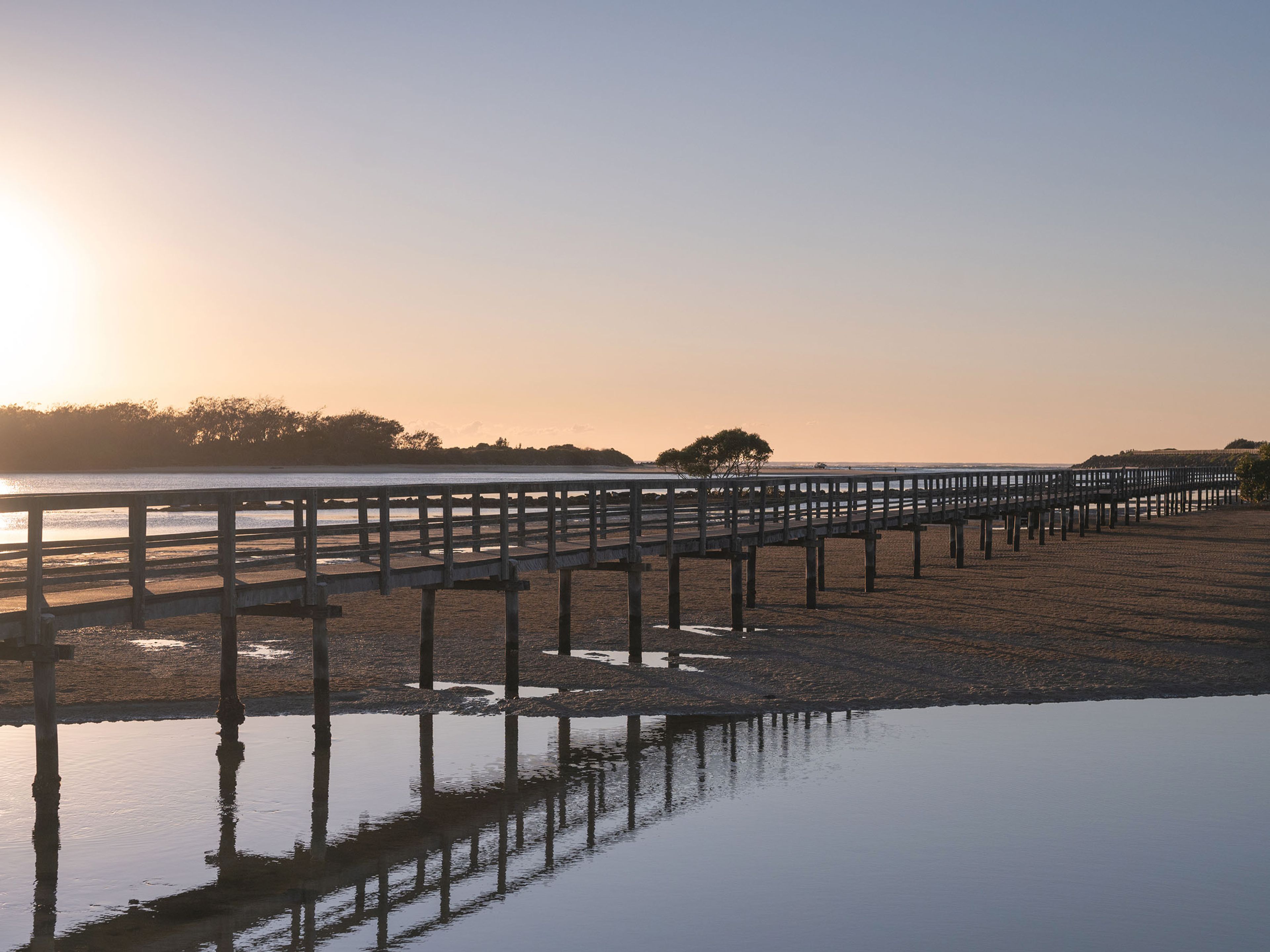 Reflections Urunga - footbridge at sunrise