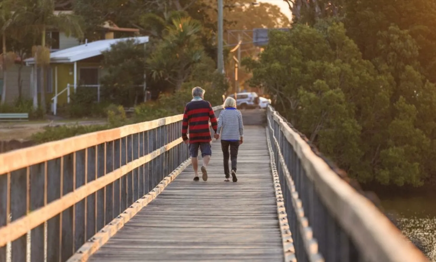 Reflections Holidays Ferry Reserve holiday & caravan boardwalk couple walking