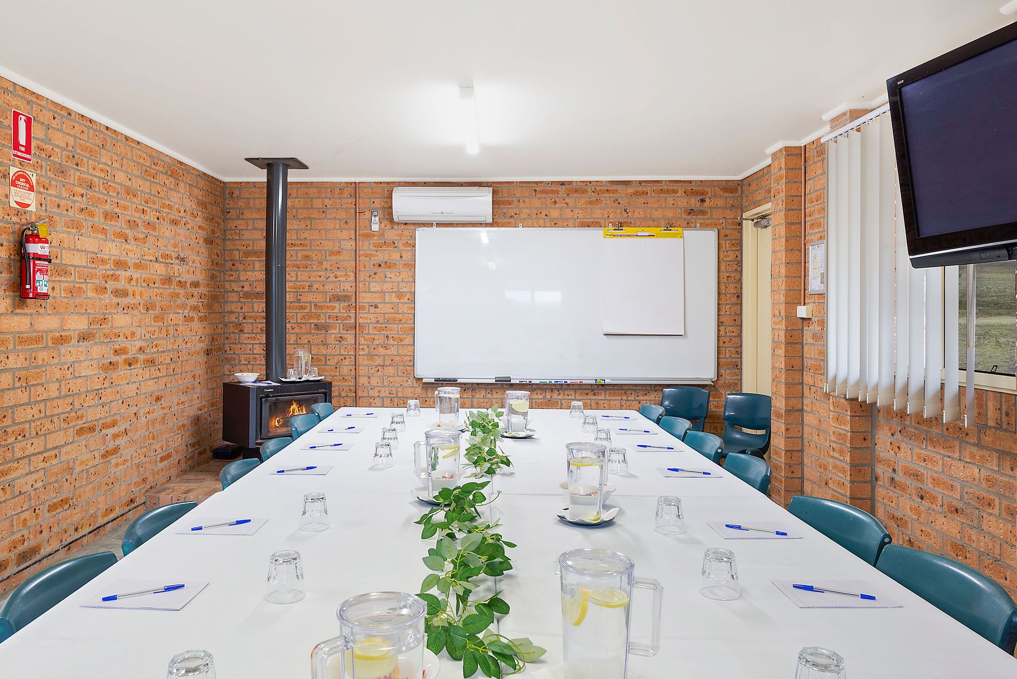 Grabine Function Centre table and fireplace and whiteboard