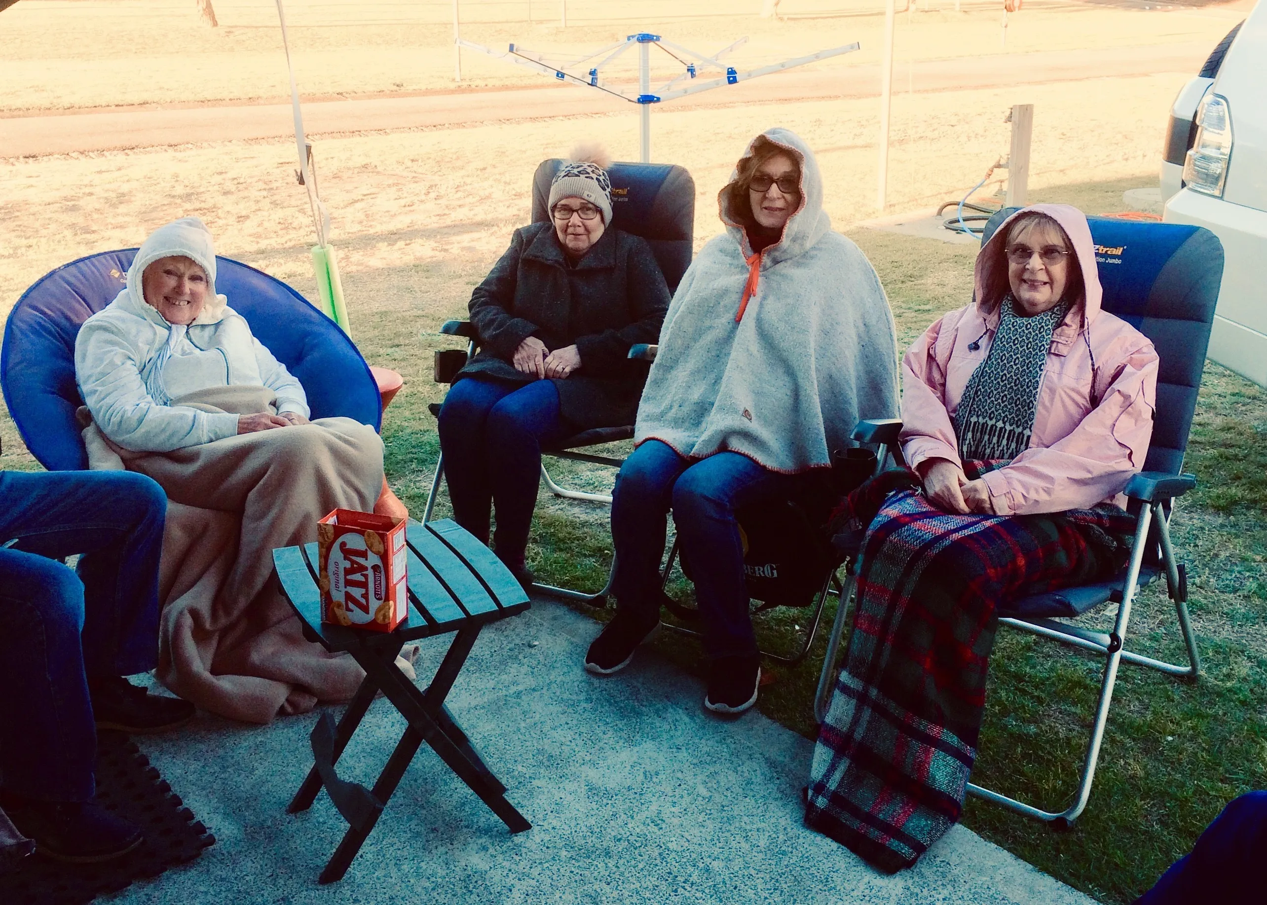 Woman sitting at Caravan park in the cold