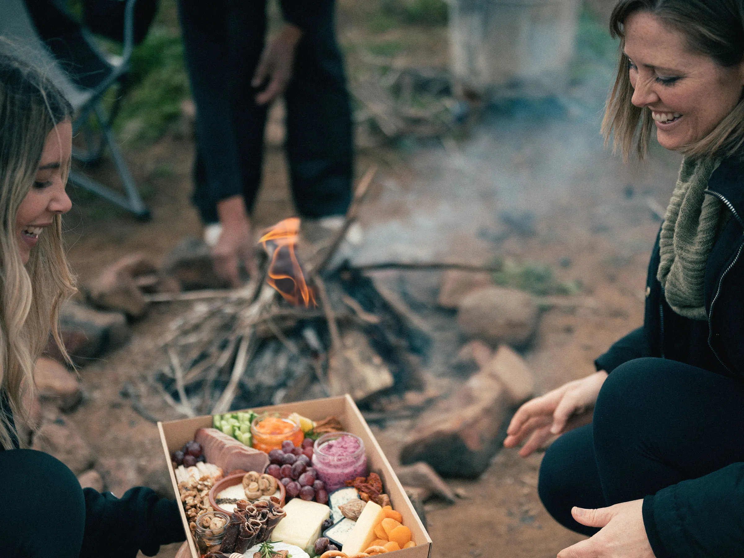 Reflections Holidays Lake Glenbawn caravan park people eating cheese board over campfire