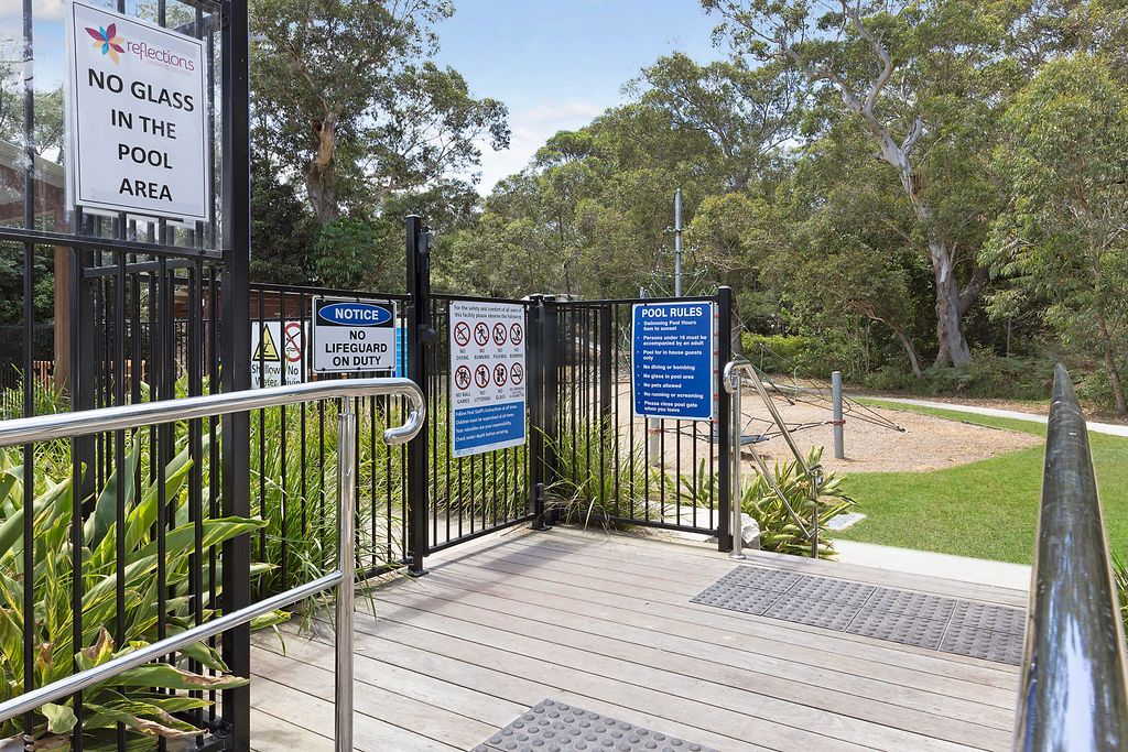 Secure pool entrance with safety signage at Reflections Jimmys Beach Caravan Park
