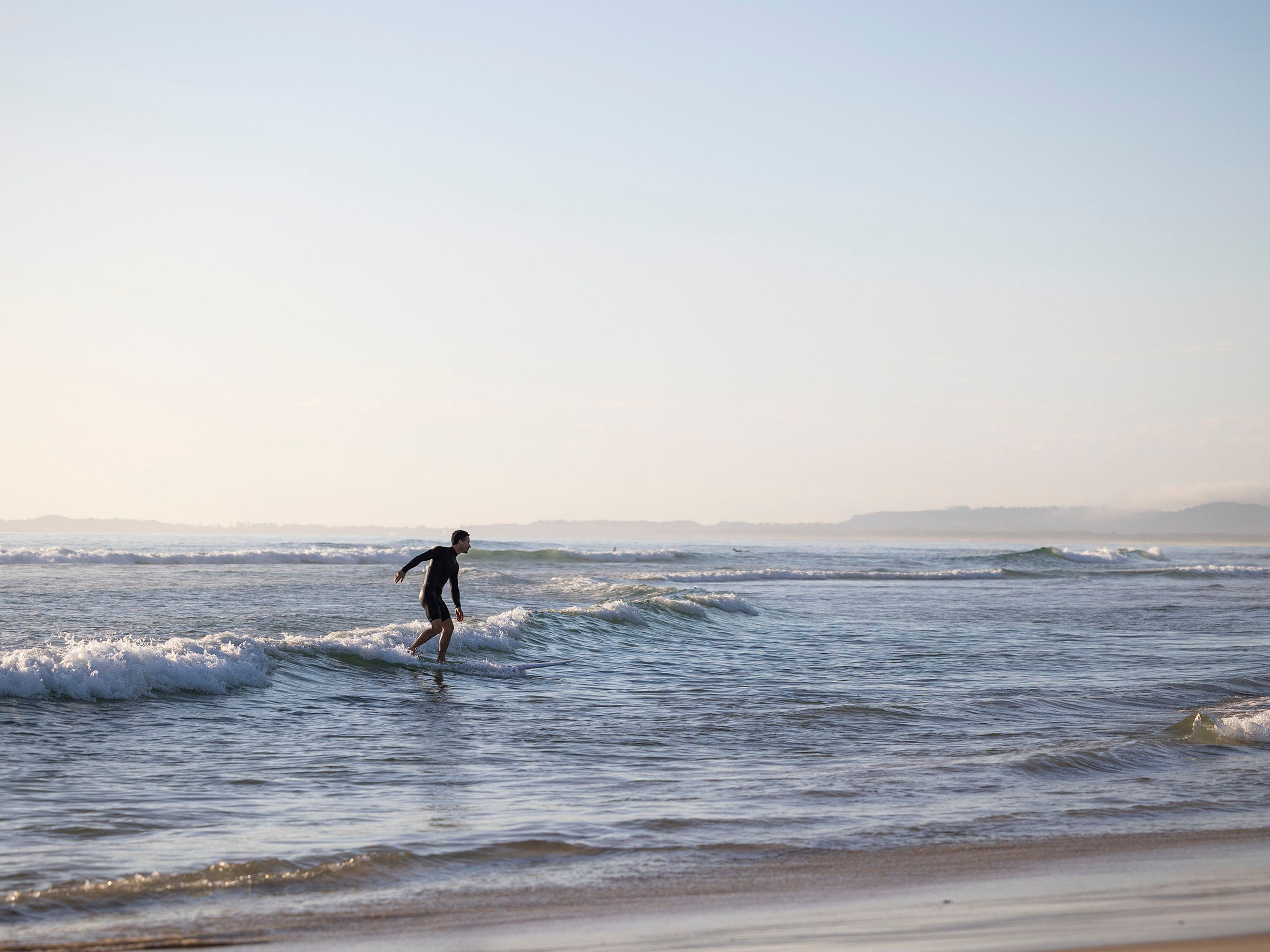 Reflections Holidays Massy Greene Holiday and Caravan Park Brunswick Heads Main Beach man surfing wave