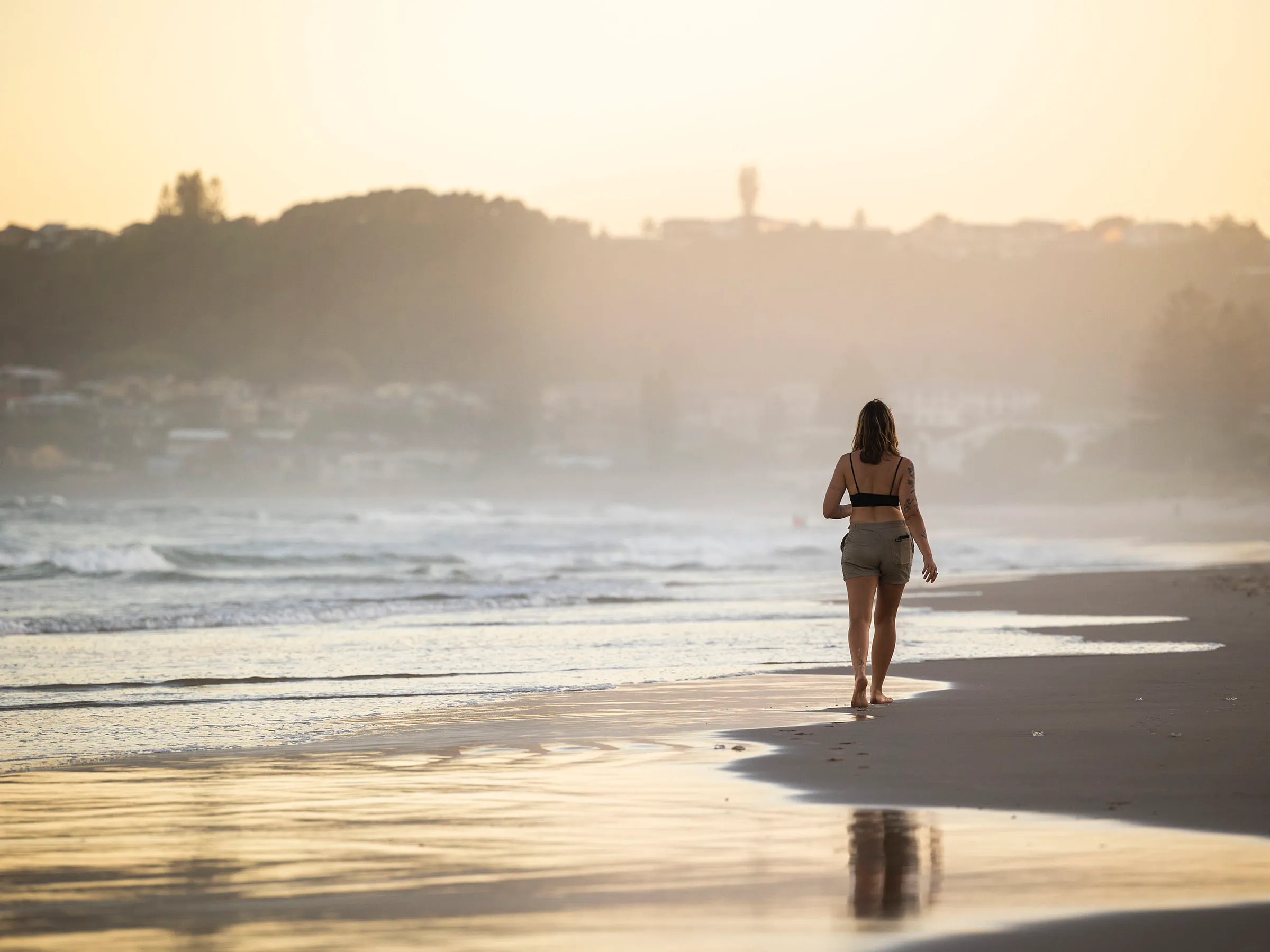 Reflections Holidays Lennox Head Person walking on Lennox Head Beach