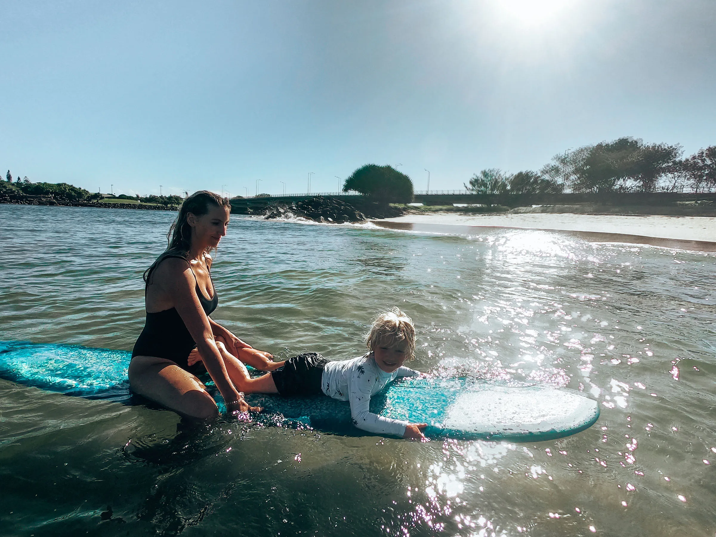 Reflections Shaws Bay holiday and caravan park mum and son surfing