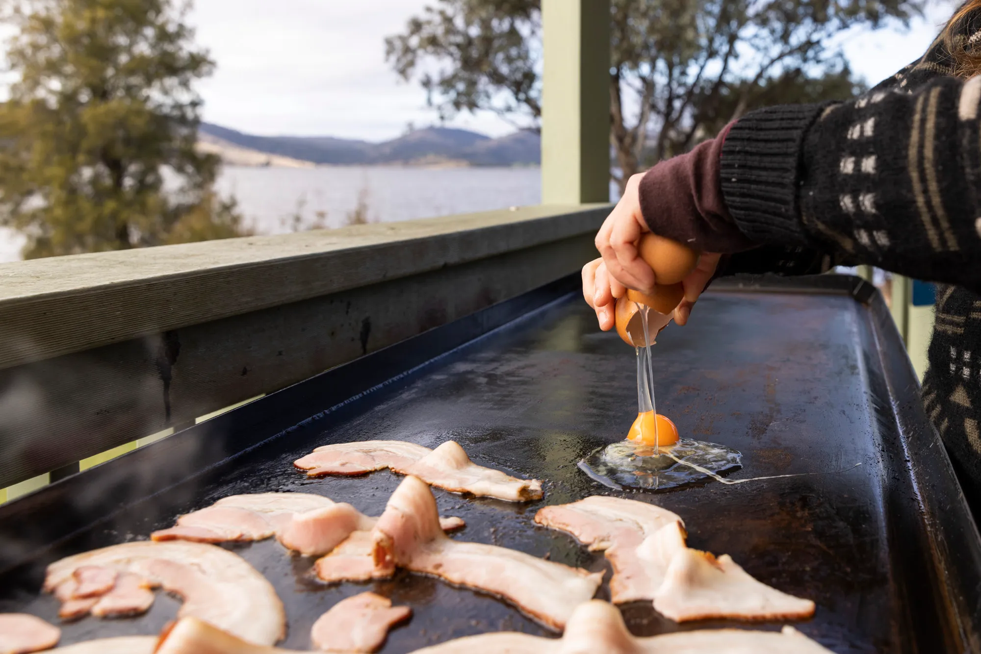 Eggs getting fried on a BBQ at a reflections park