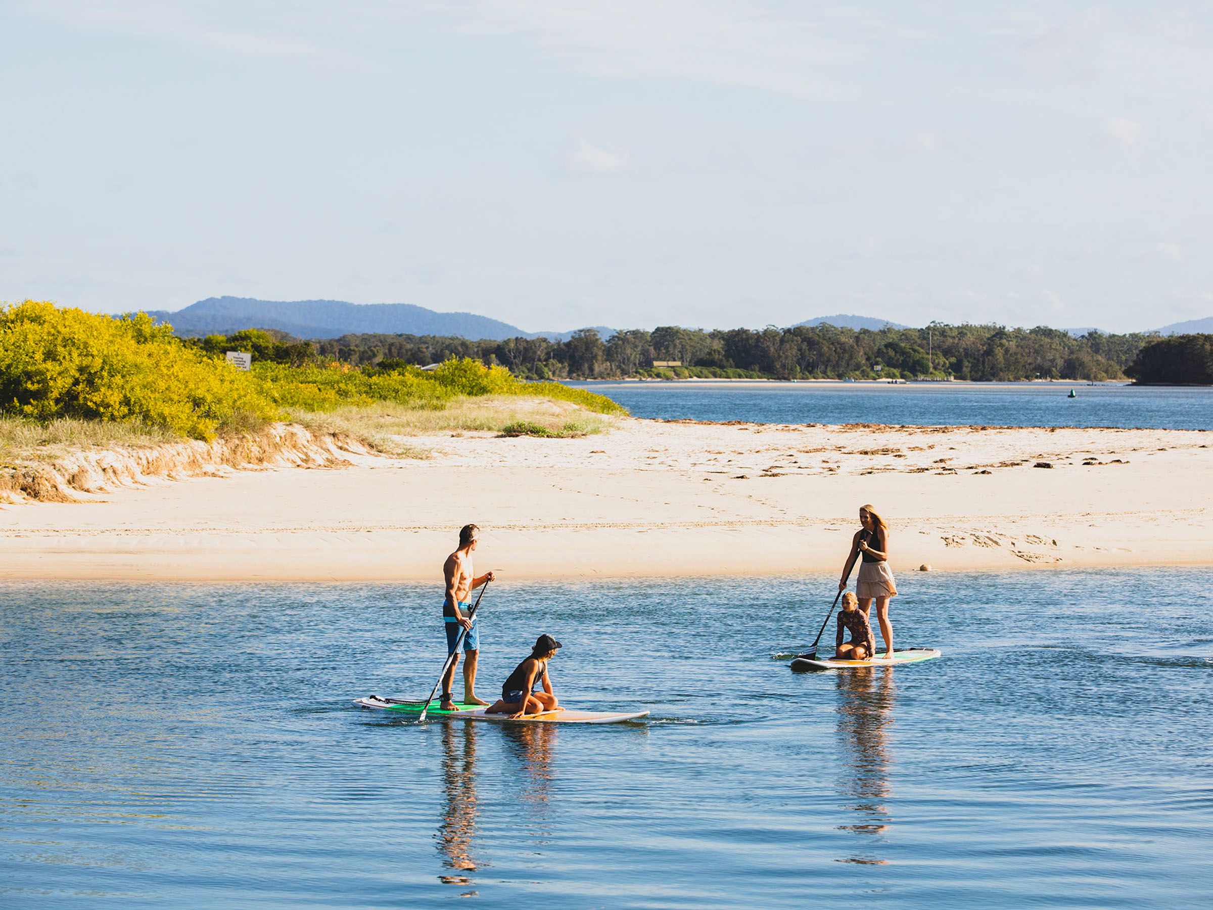 Reflections Tuncurry holiday and caravan park people stand up paddle boarding on Coolongolook River 178674-56 destination NSW