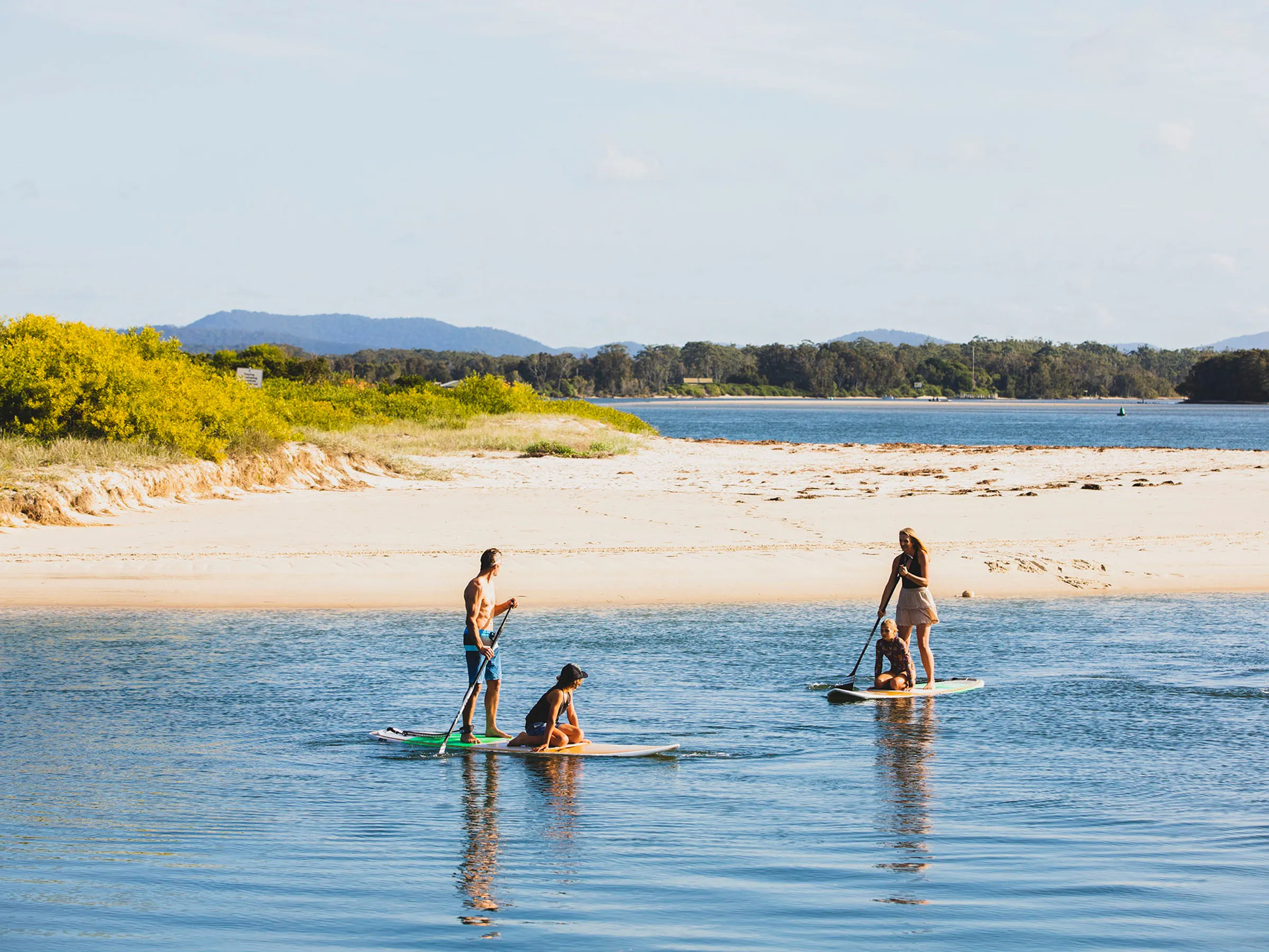 Reflections Tuncurry holiday and caravan park people stand up paddle boarding on Coolongolook River 178674-56 destination NSW