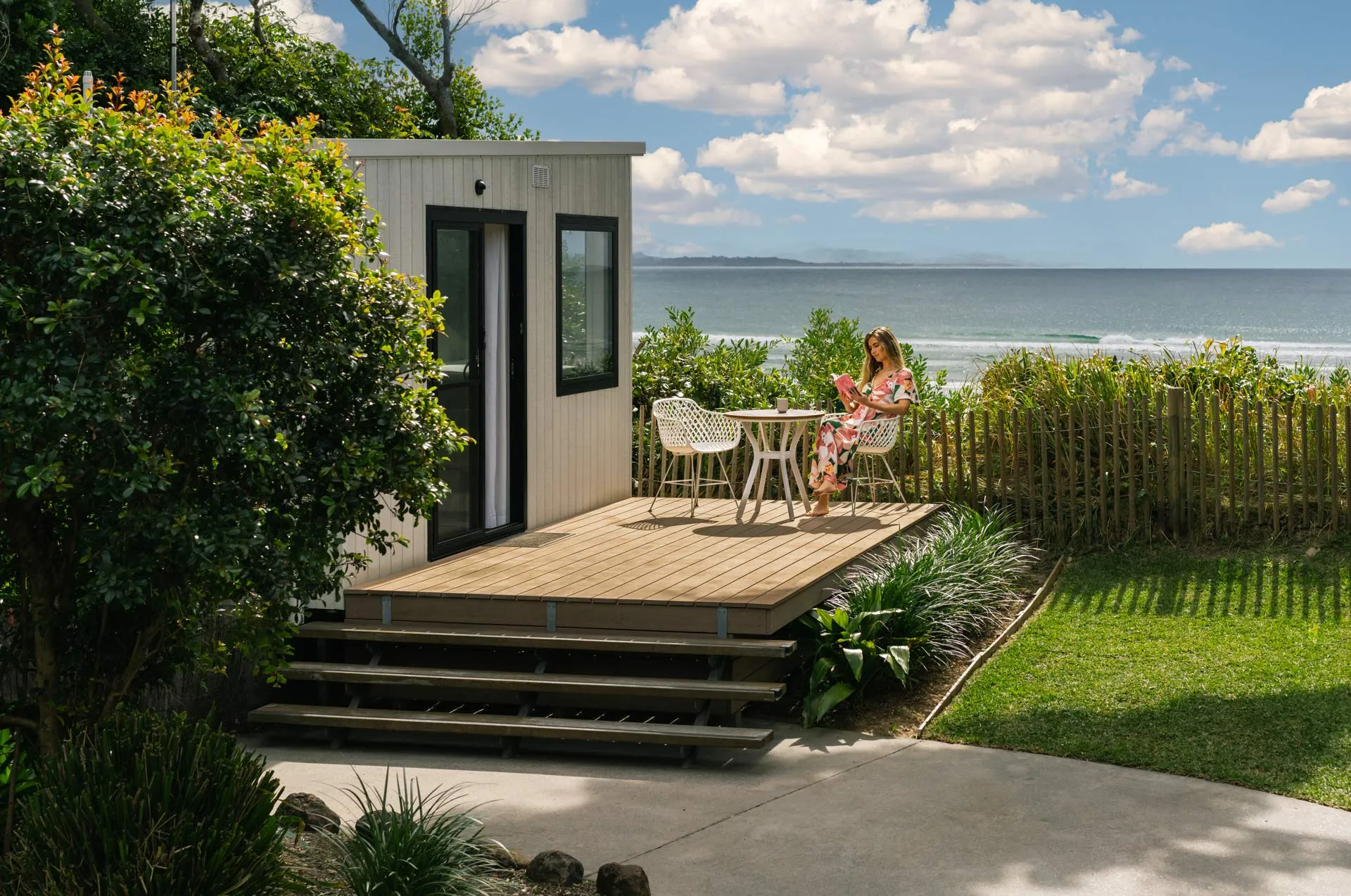 Reflections Byron Bay solo woman reading a book at Tiny Home 56