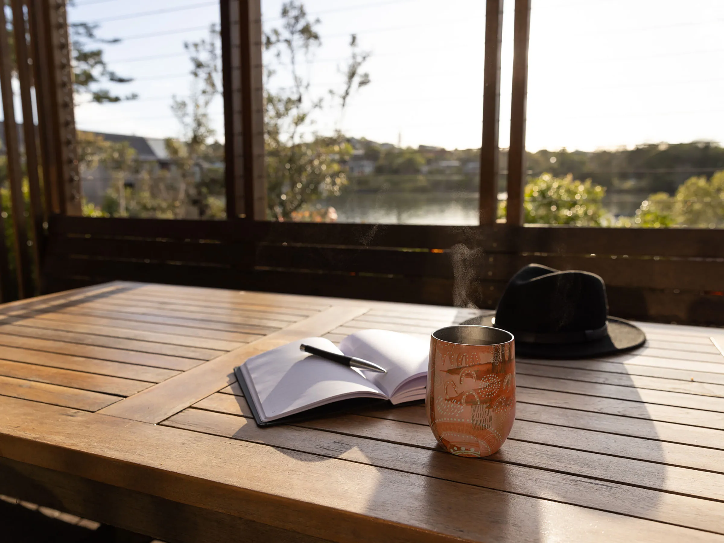 Reflections Holidays Evans Head holiday & caravan park reading a book and coffee over looking Evans River