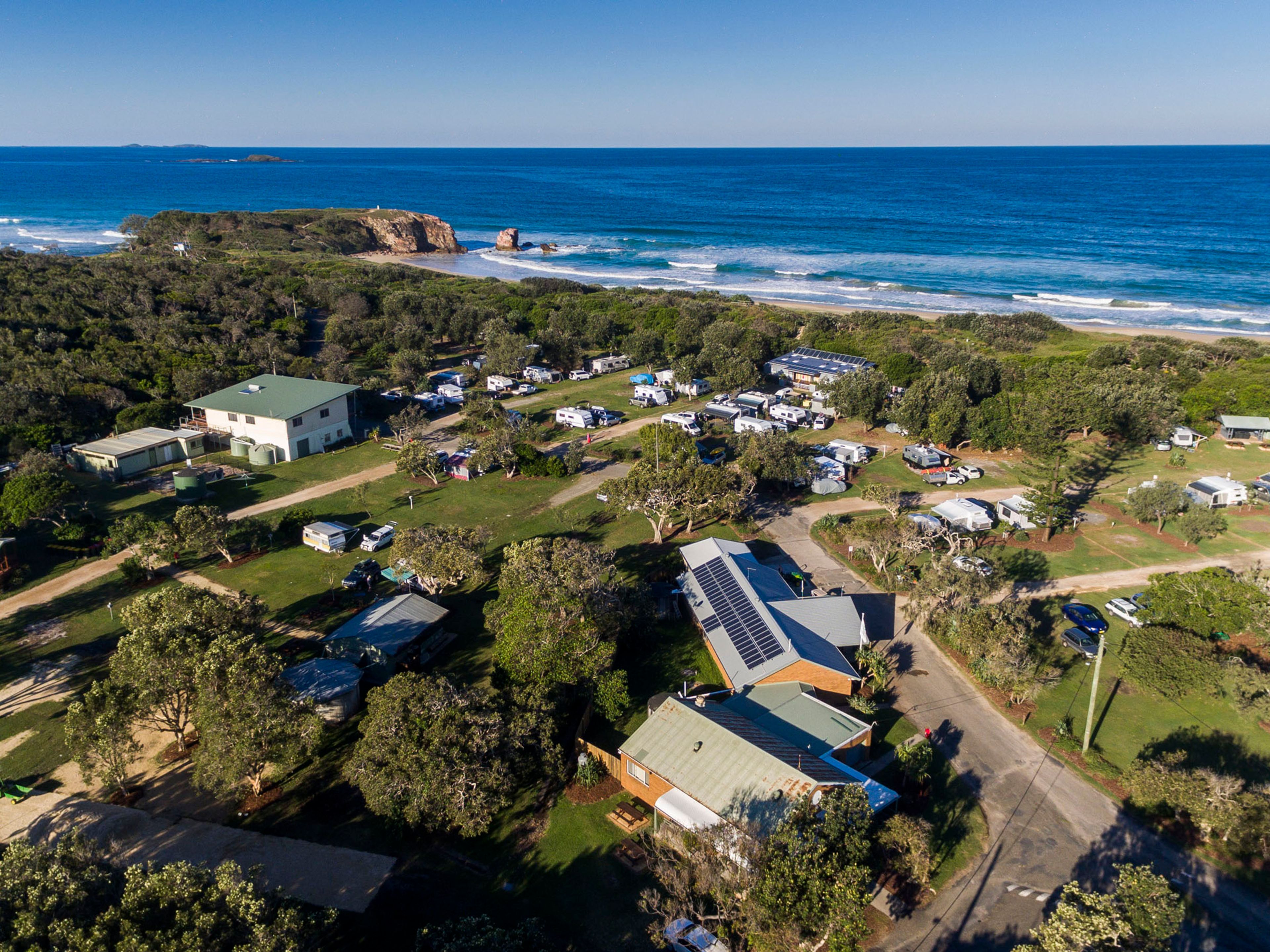 Reflections Red Rock holiday and caravan park ocean view drone photo
