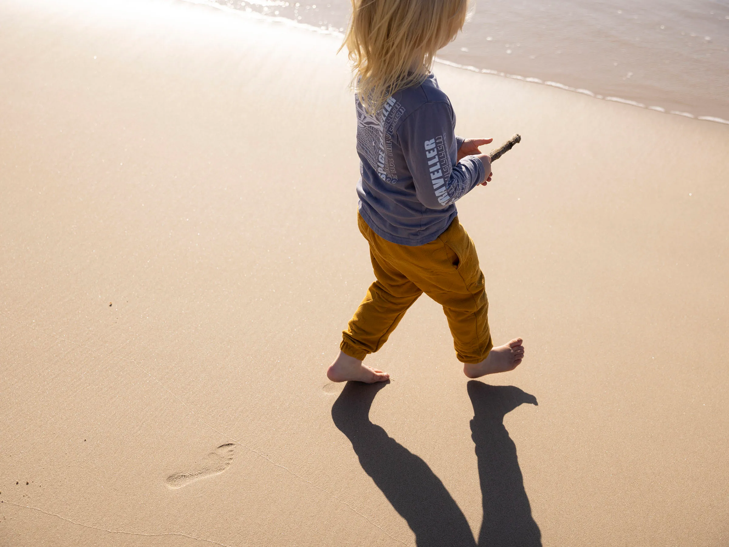 Reflections Tuncurry holiday and caravan park child walking on 9 mile beach