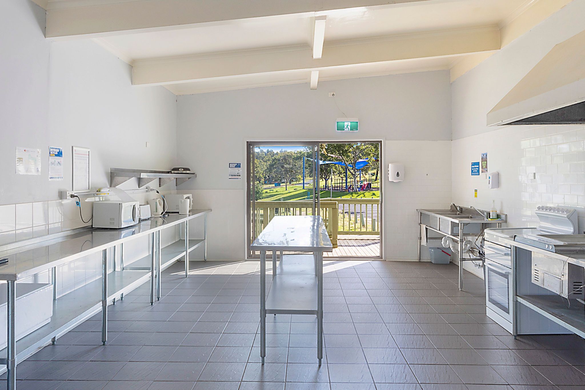 Fully equipped kitchen interior with ovens, microwaves, kettles, and stainless steel benches at Reflections Wyangala Waters