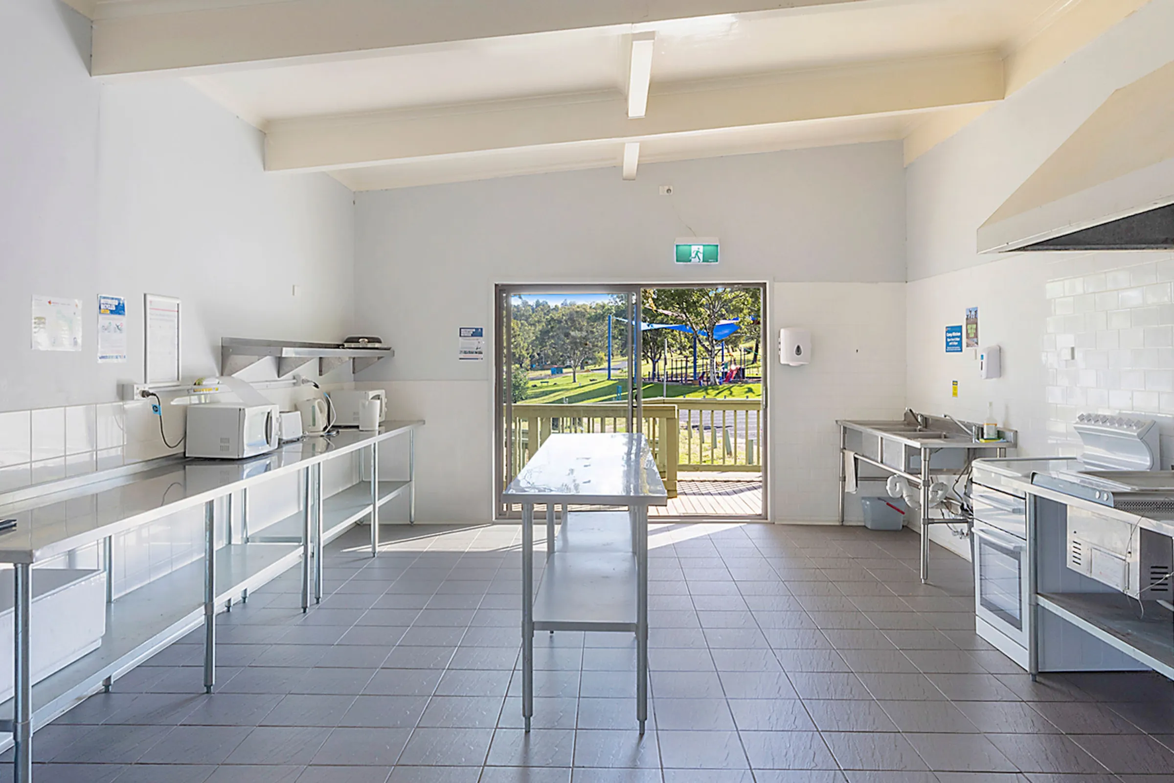 Fully equipped kitchen interior with ovens, microwaves, kettles, and stainless steel benches at Reflections Wyangala Waters