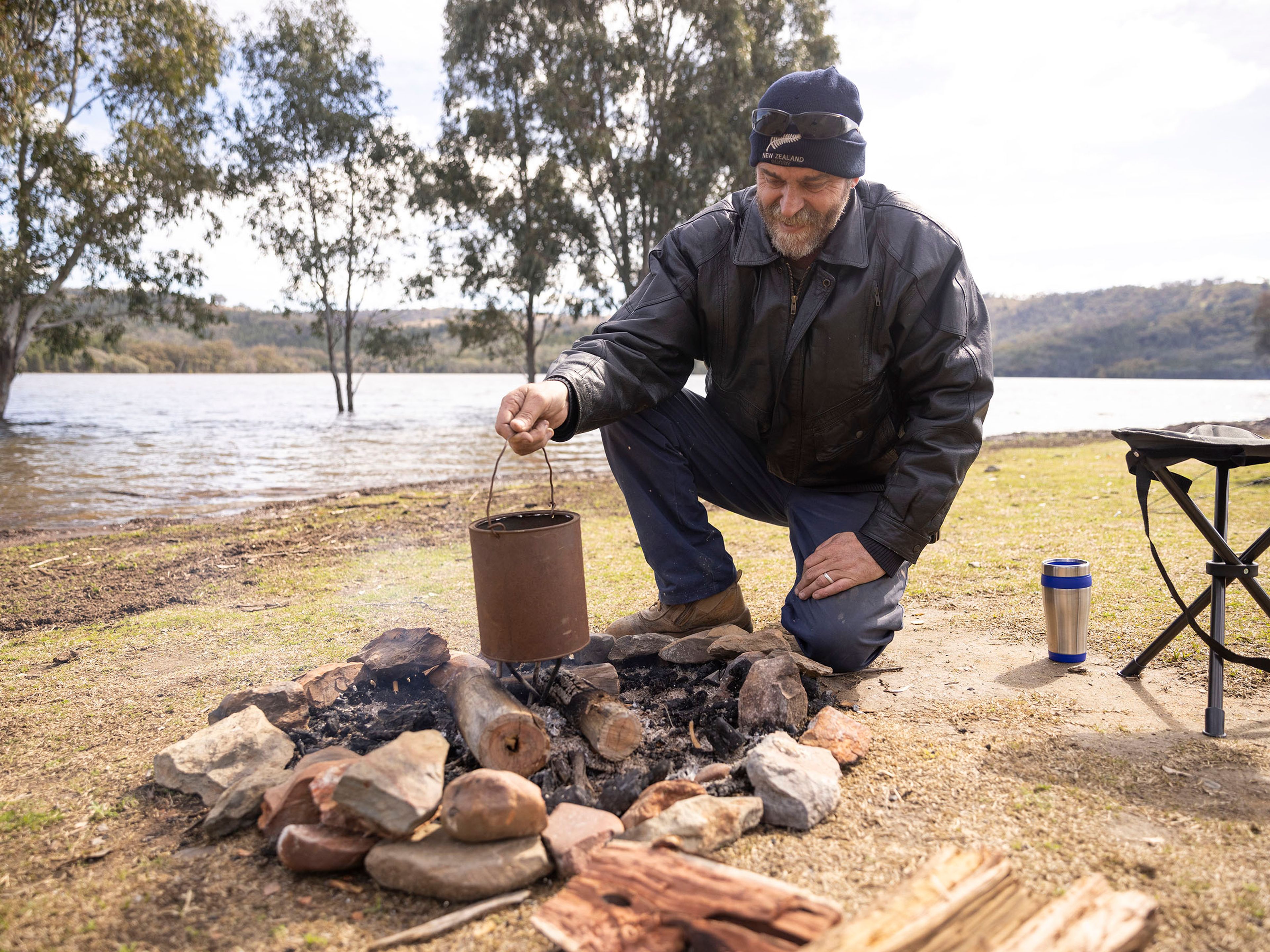 Reflections Holidays Lake Burrendong holiday and caravan park man boiling water over campfire