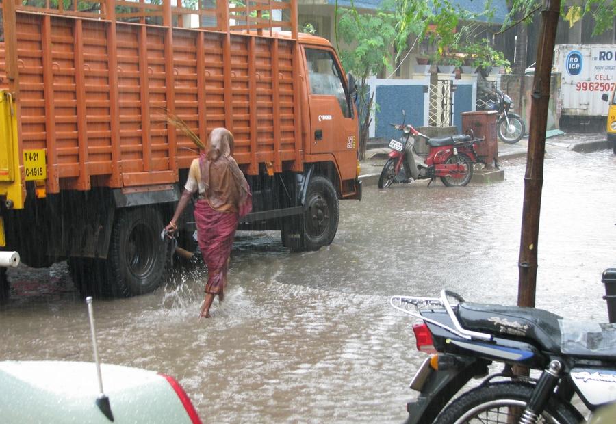 Heavy monsoon rains and waterlogged street during IMD weather alert