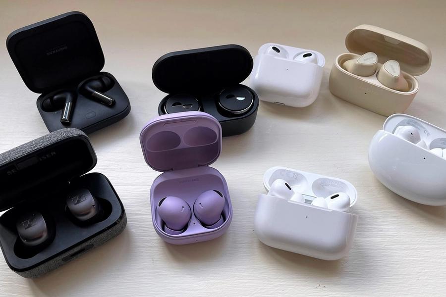 A selection of true wireless earbuds displayed in their charging cases.