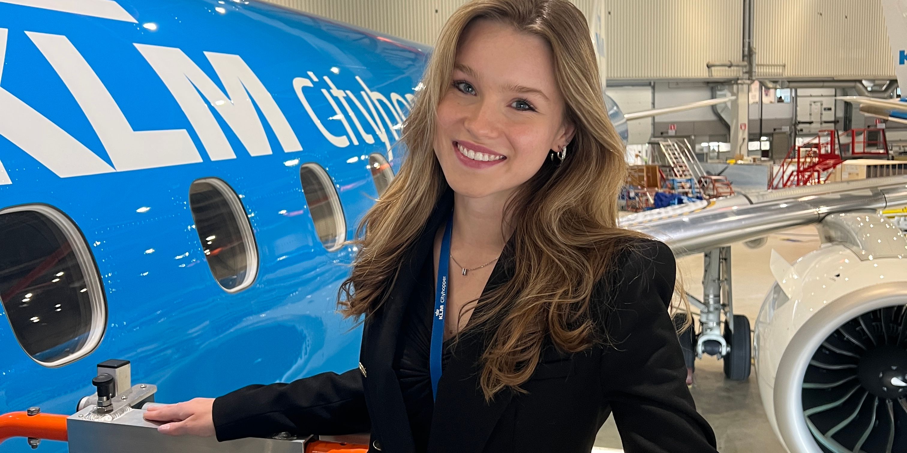 Nika KLM Cityhopper intern posing infront of a KLM Cityhopper airplane