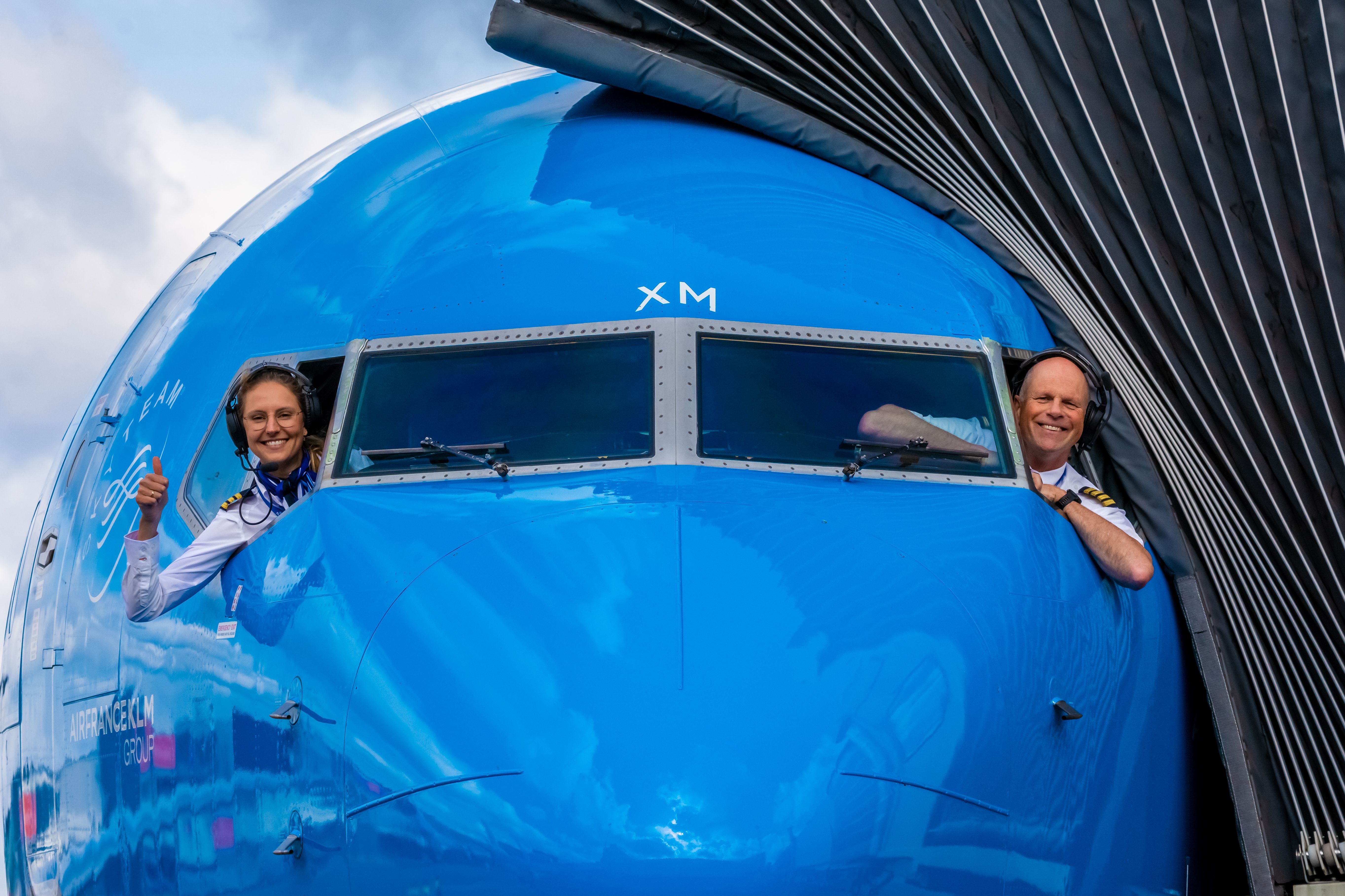 Two pilots looking out of the airplane window